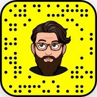 a man with glasses and a beard on a yellow background